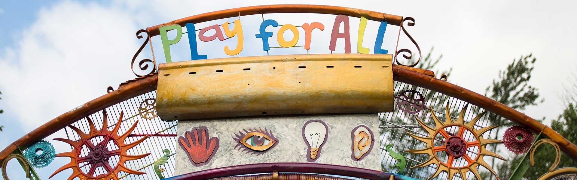 “Art Along the Way” archway sculpture at entrance to playground