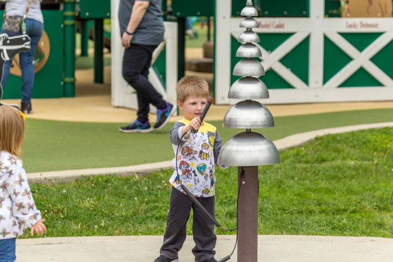 Young boy plays on sound garden equipment