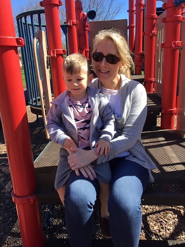 Margie and grandson sitting in the playground