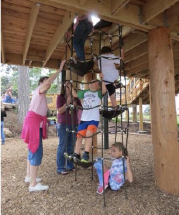 vertical netting playground equipment with children playing