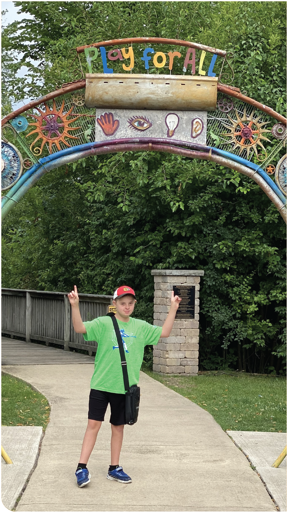 Boy in front of Play for All arch entrance